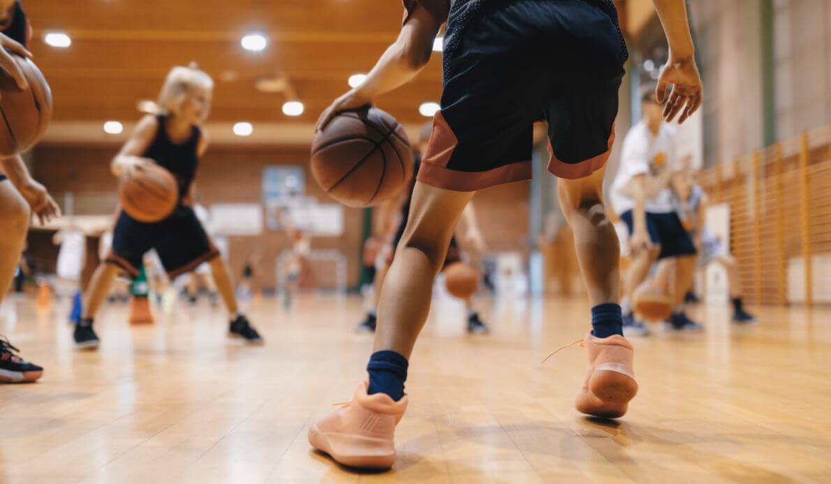 Image of people playing basketball in a gymnasium